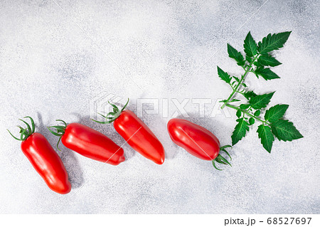 Red finger tomatoes on grey textured backdrop, Red finger tomatoes on grey textured backdrop, 68527697