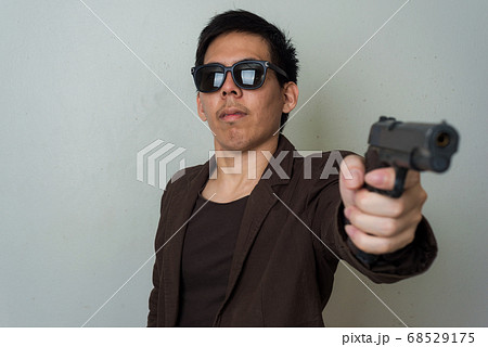 Powerful killer with semi automatic gun on white Powerful killer with semi automatic gun on white 68529175