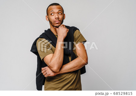 african-american young man in green t-shirt over light grey background with copy space 68529815