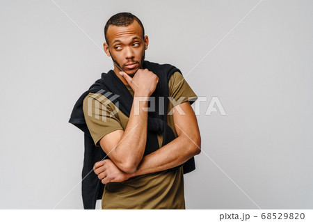 african-american young man in green t-shirt over light grey background with copy space 68529820