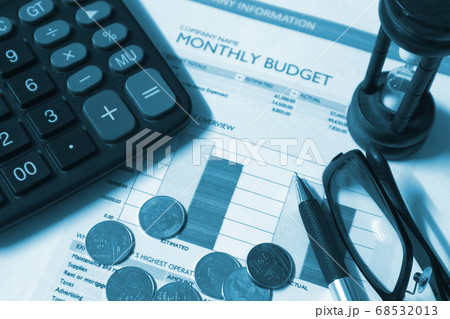 Financial paper and coins and pen and glasses and sand-hour, business concept. Financial paper and coins and pen and glasses and sand-hour, business concept. 68532013