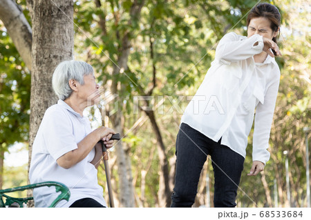 Senior woman with fever,cough and sneezing without protection,elderly patient should find a mask to prevent the spread of Covid-19 and protect others,risk symptoms of Coronavirus,influenza pandemic 68533684