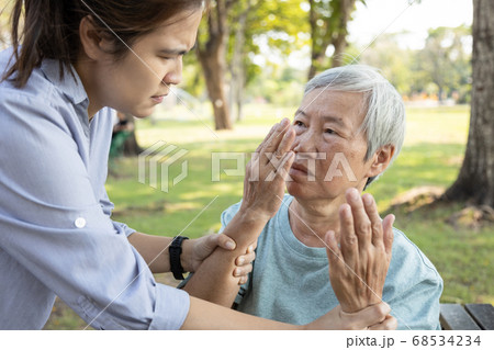 Asian daughter is forbidding her senior mother from touching the face,dirty hands risk of bacteria or germs into the mouth and nose,preventing Coronavirus infection,protection outbreak of the Covid-19 Asian daughter is forbidding her senior mother from touching the face,dirty hands risk of bacteria or germs into the mouth and nose,preventing Coronavirus infection,protection outbreak of the Covid-19 68534234