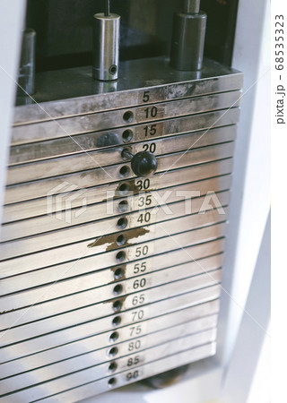 Fitness gym, detail of the lot machine, weights 68535323