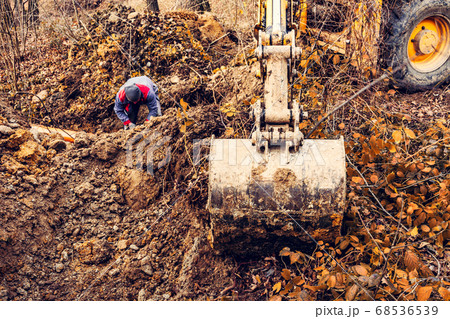 An excavator in the forest digs a ladle for fish 68536539