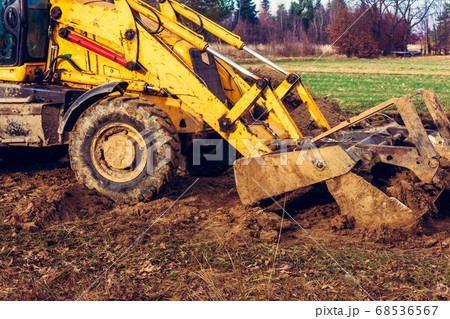 The excavator is digging the ground for the The excavator is digging the ground for the 68536567