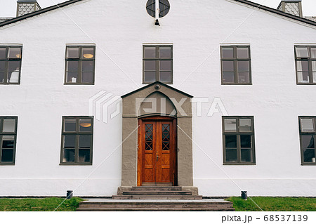 The facade of a white two-story building in Reykjavik, the capital of Iceland. The facade of a white two-story building in Reykjavik, the capital of Iceland. 68537139