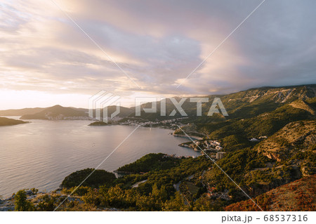 Budvan Coast. Mountains and cities along the road on the Adriatic coast in Montenegro, at sunset. 68537316