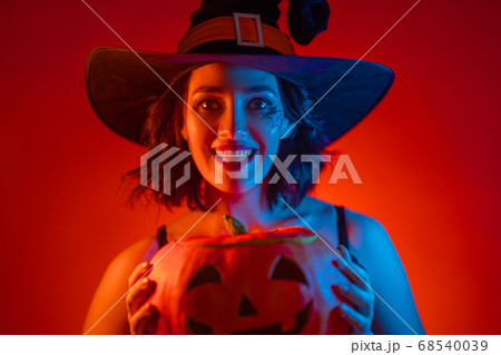 Young woman in black witch costume 68540039