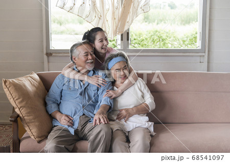 Asian young woman hug and take care senior parent Asian young woman hug and take care senior parent 68541097
