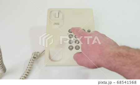 Hand picks up the phone dials the number , old 68541568