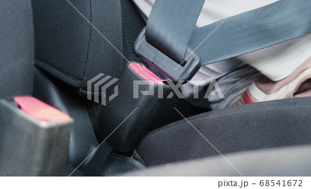 Male hand fastening car safety seat belt before Male hand fastening car safety seat belt before 68541672