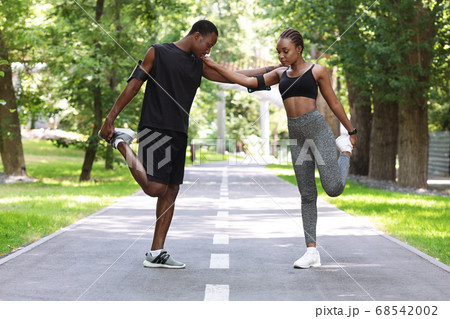 Couple Workout. Fit African Couple Doing Fitness Training Together In City Park Couple Workout. Fit African Couple Doing Fitness Training Together In City Park 68542002