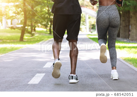 Personal Training Outdoors. Black Woman Running In Morning Park With Male Coach Personal Training Outdoors. Black Woman Running In Morning Park With Male Coach 68542051