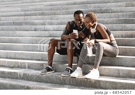 Fitness App. Motivated Couple Checking Sport Activity On Smartphone After Training Outdoors 68542057