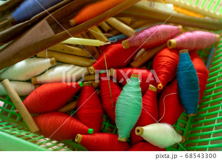 Top view yarns on spool and empty wooden spool. Top view yarns on spool and empty wooden spool. 68543300