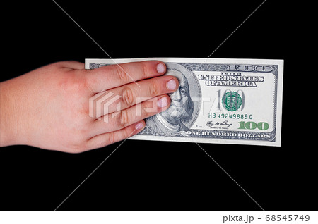 man's hand holds a one hundred US dollar bill with man's hand holds a one hundred US dollar bill with 68545749