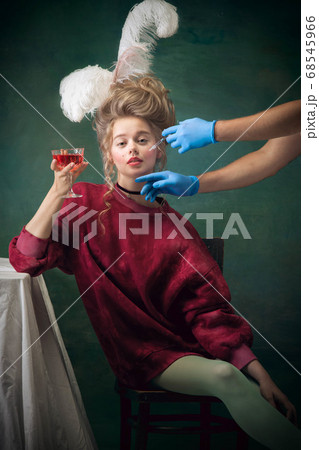 Young woman as Marie Antoinette on dark background. Retro style, comparison of eras concept. 68545966