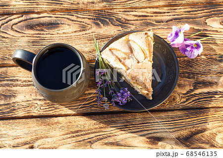 Piece of apple pie with ceramic handmade cup of 68546135