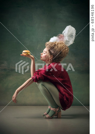 Young woman as Marie Antoinette on dark background. Retro style, comparison of eras concept. 68546196