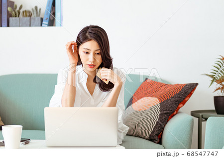 Young woman shopping online with credit card and laptop at home Young woman shopping online with credit card and laptop at home 68547747