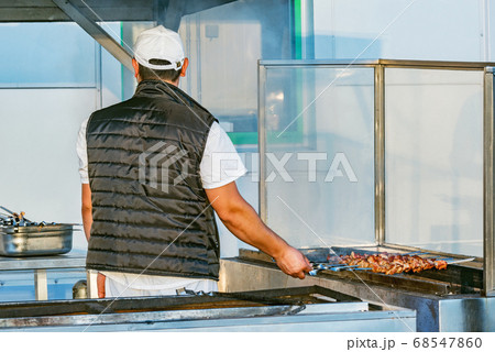 Cooking of the barbecue on the city street. 68547860