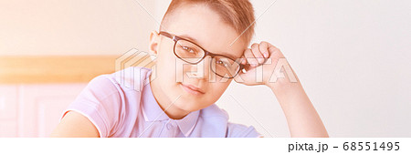 Little boy in eyeglasses thinking at home. Schoolboy study Little boy in eyeglasses thinking at home. Schoolboy study 68551495