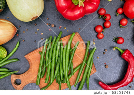 chopped green beans on a wood board with vegetables one chopped green beans on a wood board with vegetables one 68551743