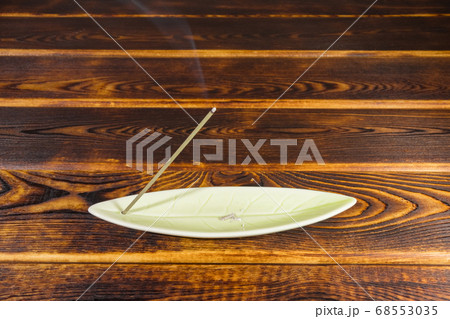 incense sticks on a wooden background isolate 68553035