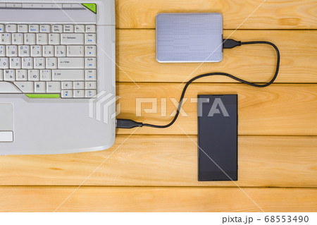 laptop on a wooden background top view 68553490