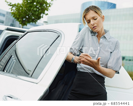 Businesswoman Takes Notes On Palm Of Hand During Phone Call Businesswoman Takes Notes On Palm Of Hand During Phone Call 68554441
