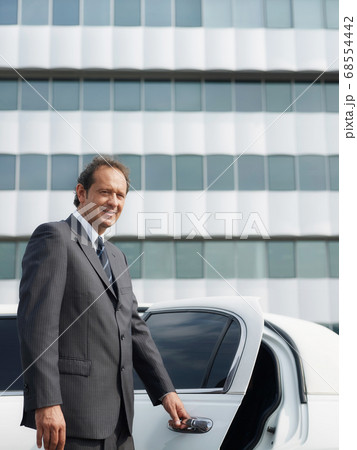 Portrait Of Man Working As Driver In White Limousine Portrait Of Man Working As Driver In White Limousine 68554442