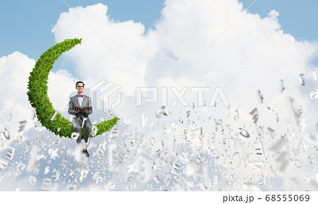 Young businessman or student studying the science and symbols fly around Young businessman or student studying the science and symbols fly around 68555069