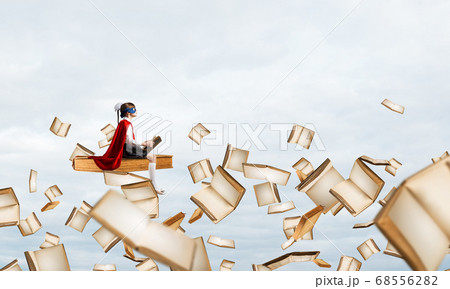 Girl power concept with cute kid guardian against cloudscape background 68556282