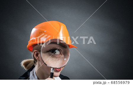 Technical inspector looking through magnifier Technical inspector looking through magnifier 68556979
