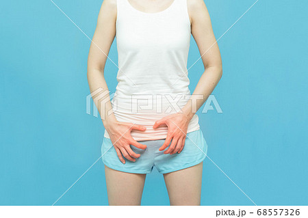 woman in white clothes put her hands on the genitalia area,hand on spot of ache and red mark, Penis pain or Itching urinary Health-care concept on blue background woman in white clothes put her hands on the genitalia area,hand on spot of ache and red mark, Penis pain or Itching urinary Health-care concept on blue background 68557326
