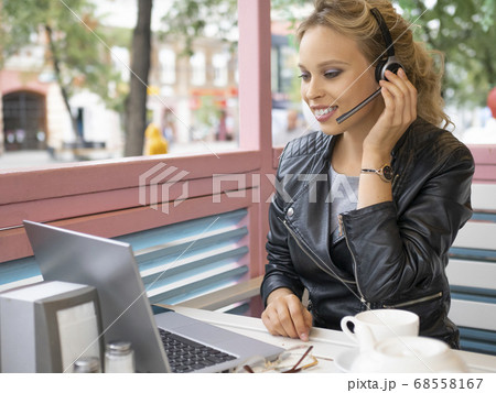 Woman having video conversation during coffee break. 68558167