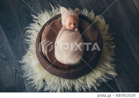 a newborn baby is smiling. A small child in a hat with ears. children's fashion 68561020