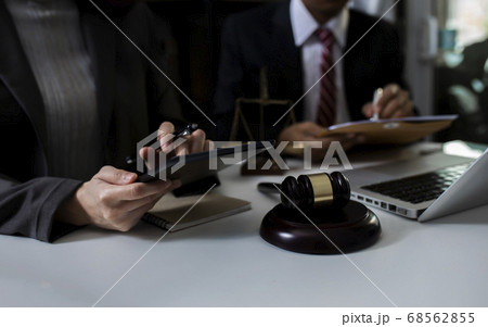 Consultation of Businessman or lawyer team meeting with client, Law and Legal services concept, Good service cooperation, Hands using tablet and laptop. Consultation of Businessman or lawyer team meeting with client, Law and Legal services concept, Good service cooperation, Hands using tablet and laptop. 68562855
