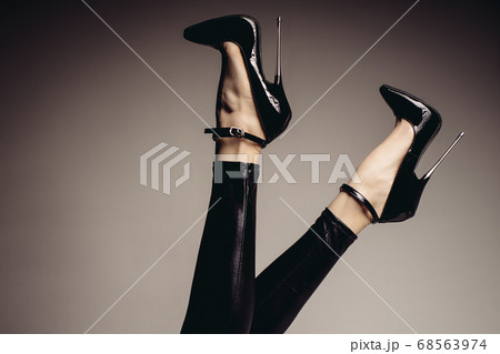 Slender female legs in spandex catsuit and a 68563974