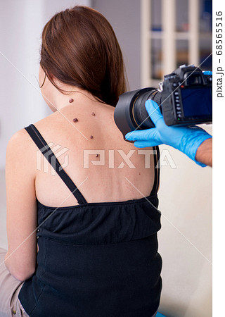 Young woman visiting male doctor dermatologist Young woman visiting male doctor dermatologist 68565516