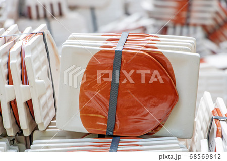 a pile of roof tiles ready to build a roof. a pile of roof tiles ready to build a roof. 68569842