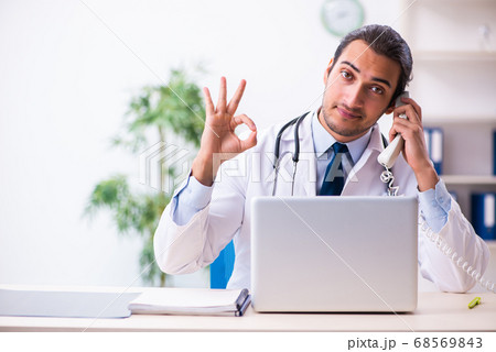 Young male handsome doctor working in the clinic 68569843