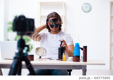 Young male cosmetician recording video for his blog 68573860