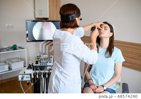 Female otolaryngologist and patient in office, exa Female otolaryngologist and patient in office, exa 68574290
