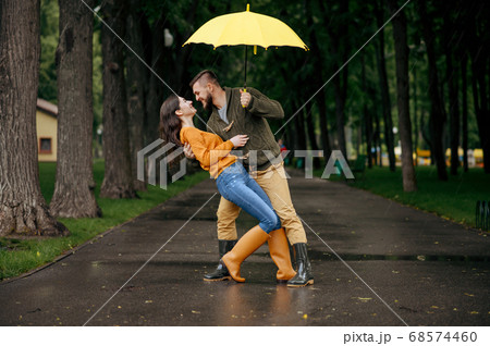Happy love couple dancing in summer rainy day 68574460