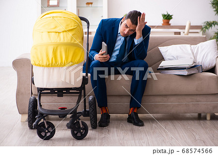 Young businessman looking after newborn at home Young businessman looking after newborn at home 68574566