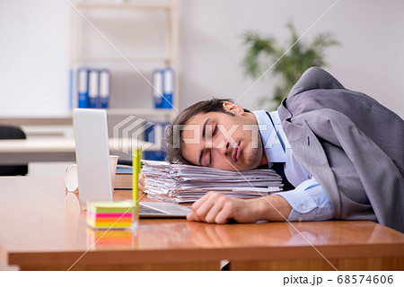 Young male employee sleeping in the office 68574606