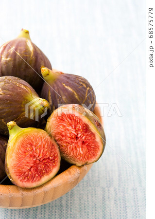 Fresh figs in bowl on blue background Fresh figs in bowl on blue background 68575779