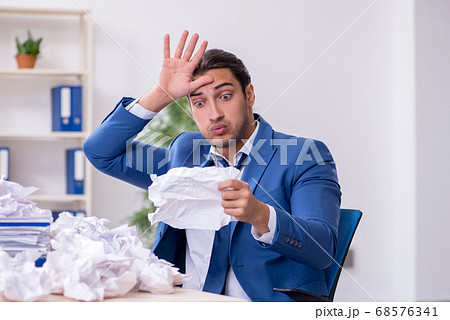 Businessman rejecting new ideas with lots of papers Businessman rejecting new ideas with lots of papers 68576341